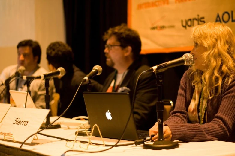 a group of people that are sitting in front of a microphone