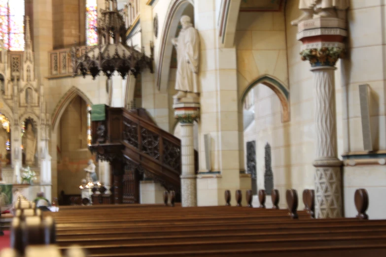 the aisle in a cathedral decorated with wooden pews