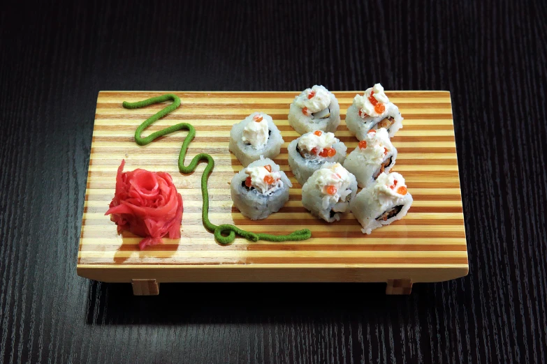 a sushi board with chop sticks and chopsticks on it