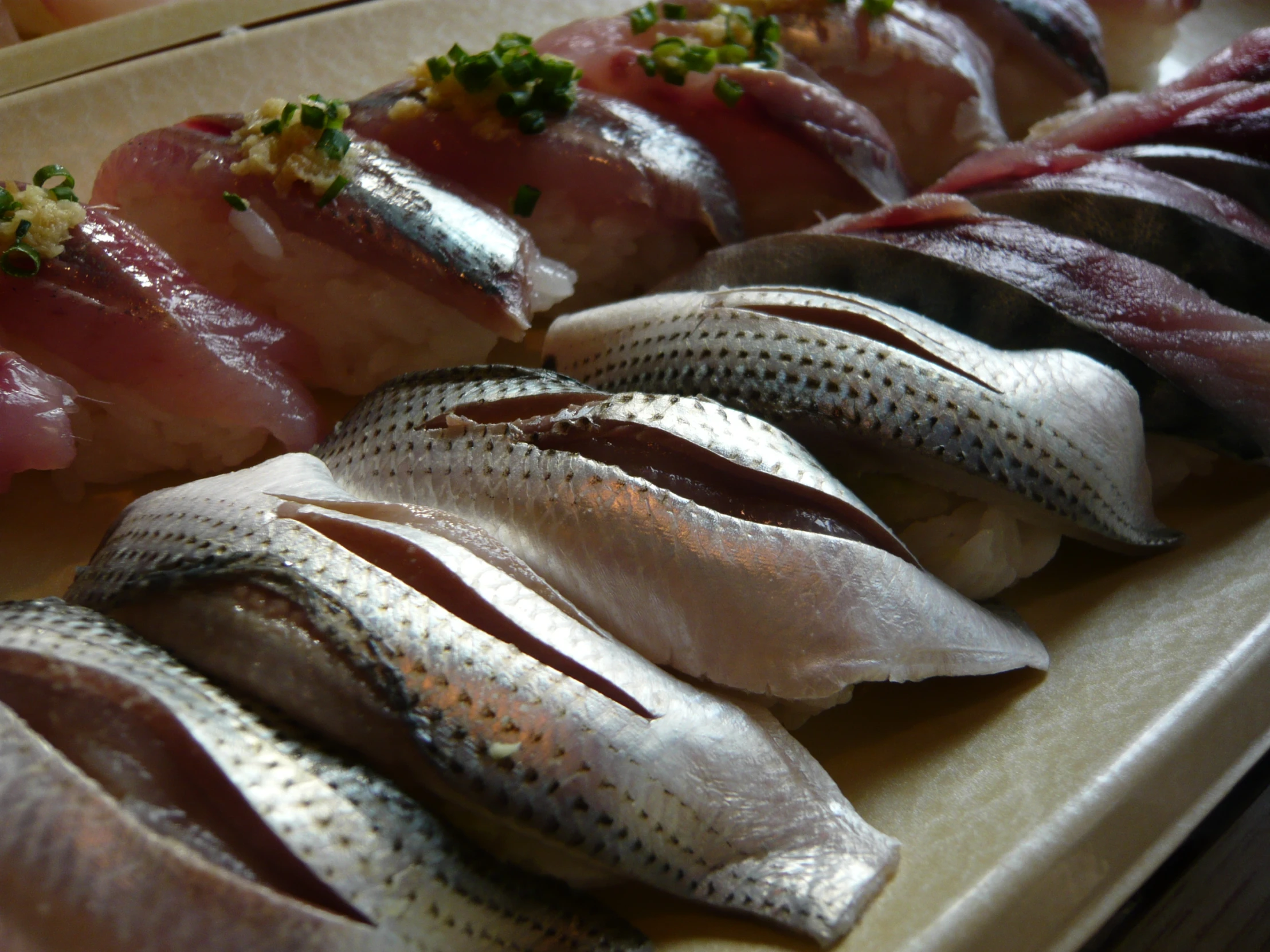 an assortment of meat wrapped in foil sitting on a table