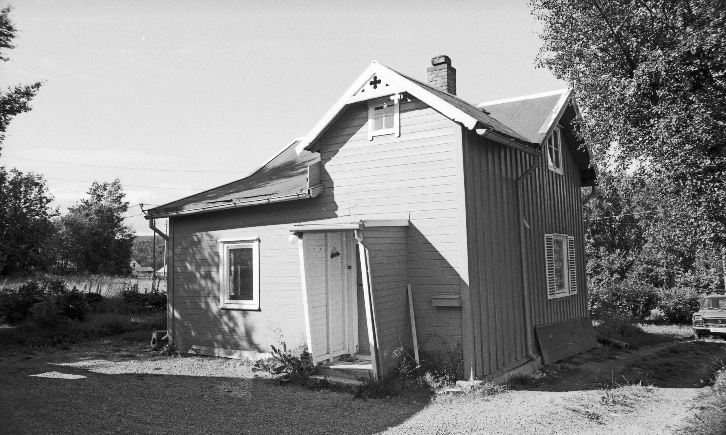 an old house sitting by a tree outside