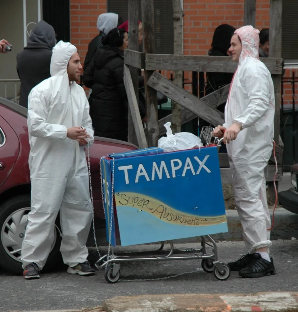 two people dressed in white carrying luggage on street