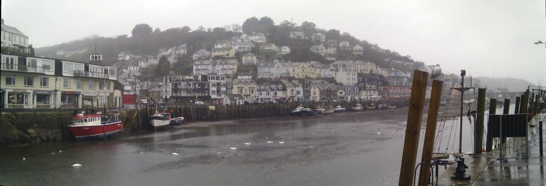 a boat docked along a bay in front of many houses