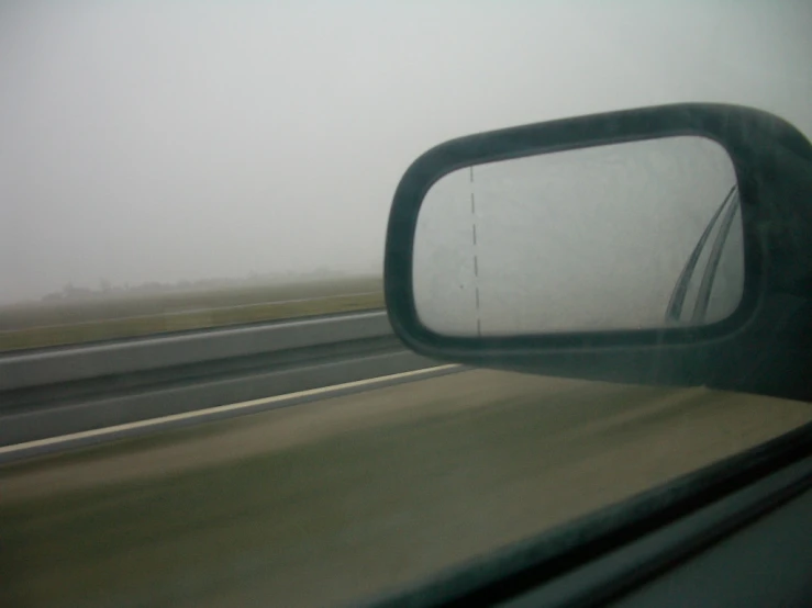 rear view mirror with the windshield of a car, viewed from inside