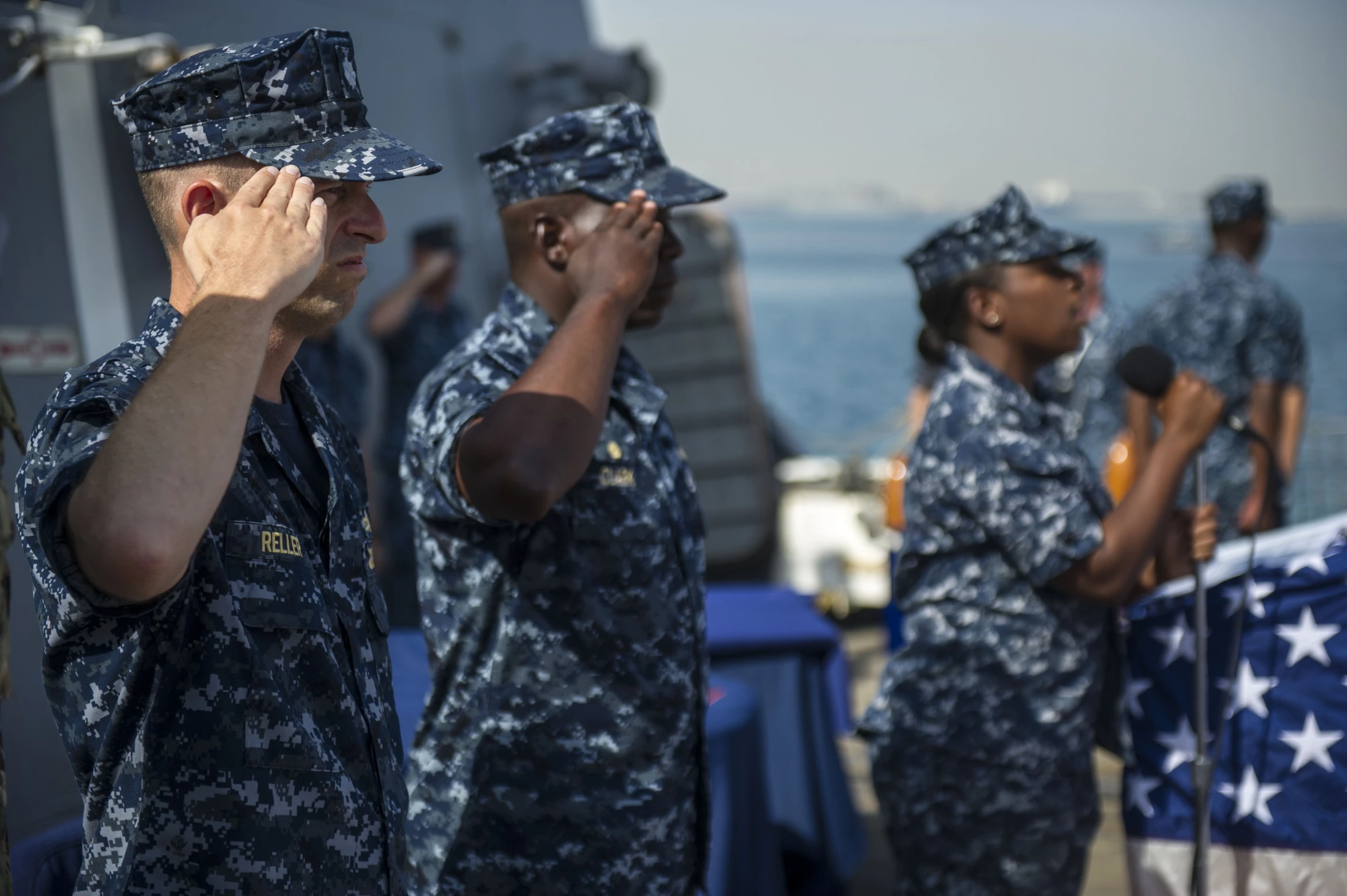 people in blue and white uniforms on a ship