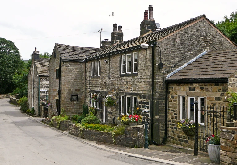 a stone building with three chimneys on the roof