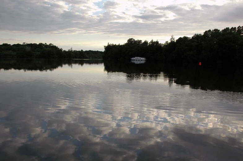 there is a boat in the water at dusk