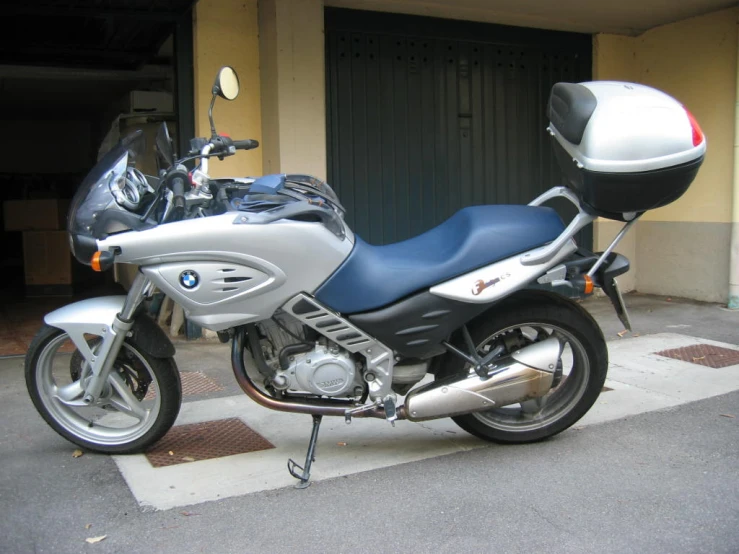 a motorcycle parked on the side of the road near some doors