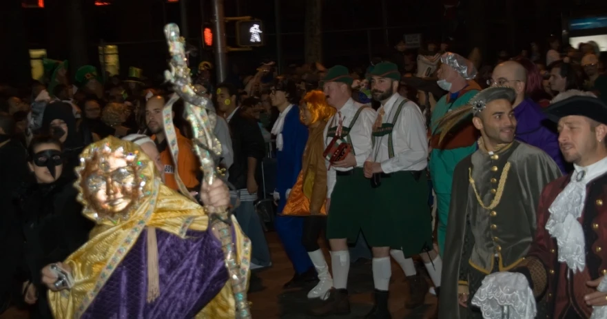 men in costume in front of people at a festival