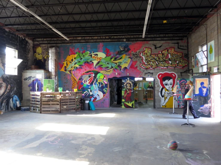 an open room with lots of different graffiti and artwork