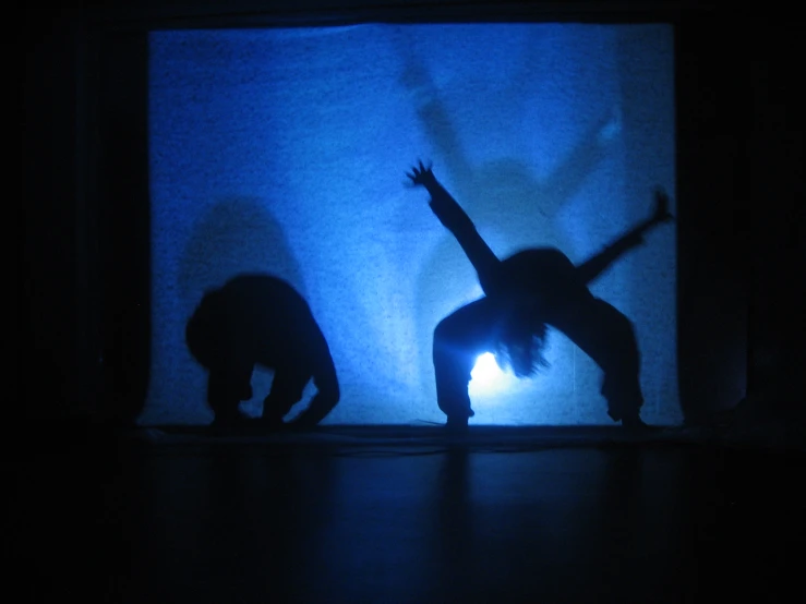 two people standing in front of a blue background