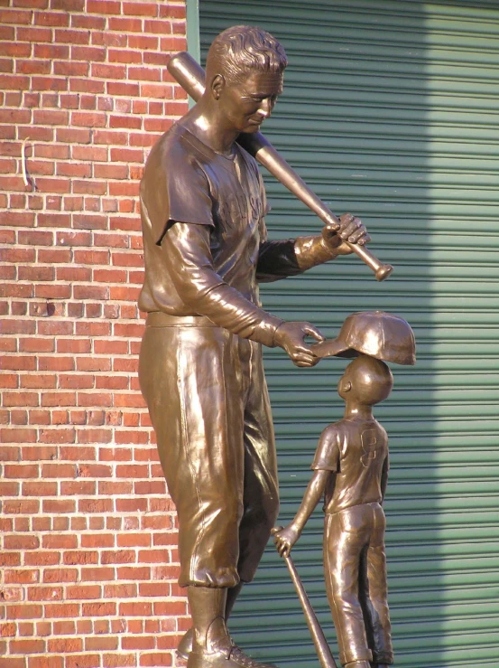 a statue that has a person and a baseball bat