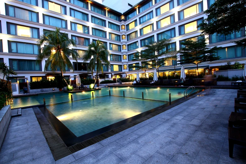 a large pool is set in a el courtyard