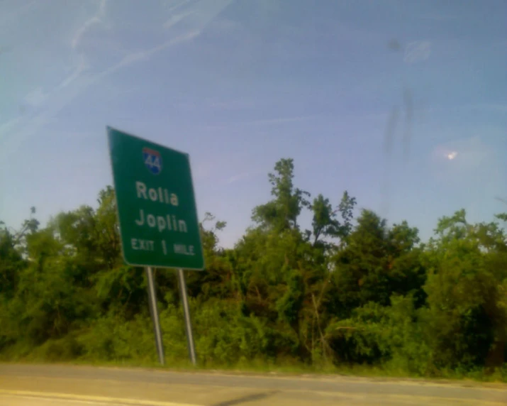 a road sign that states rolla, joshua and mississippi