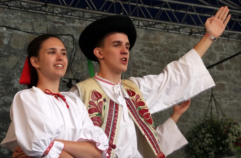 two people in colorful dress dance with each other