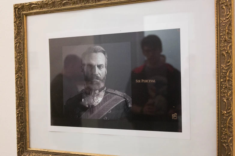 a picture in a gold frame on a wall