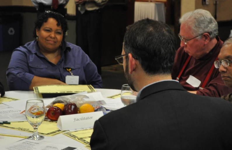 people are gathered around a table together in an office