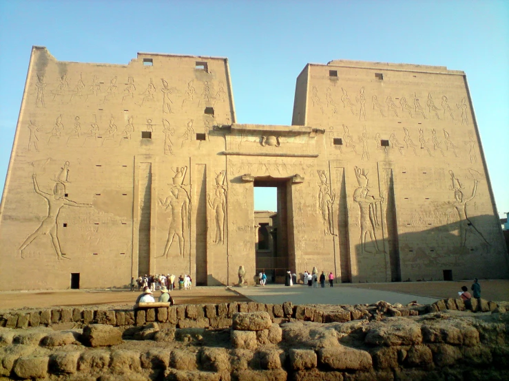 two giant egyptian statues with a sky in the background