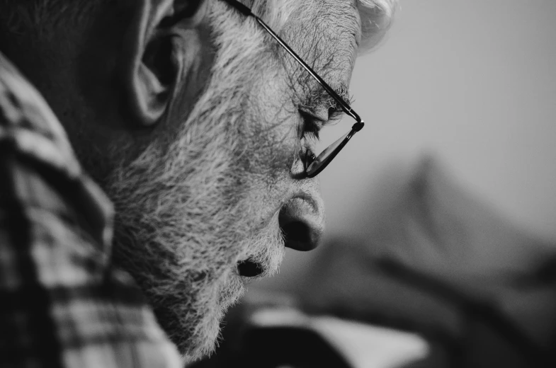 black and white image of an elderly man wearing glasses