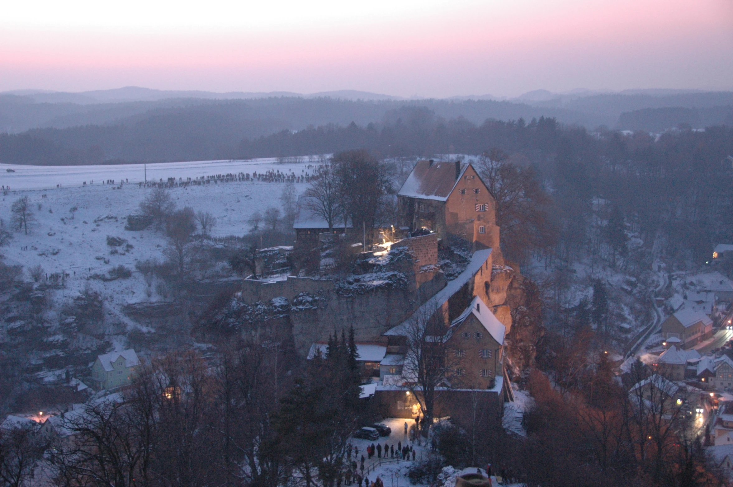 there is a snowy town with a red roof in the middle of it