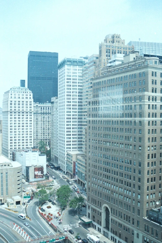 looking down at a busy city street with many tall buildings