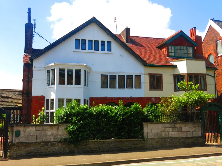 an old house with a big white fence