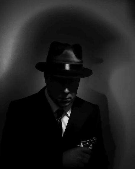 a man in black is standing wearing a hat