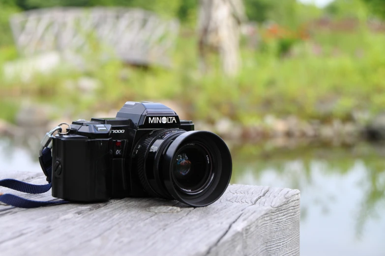 a camera sitting on top of a wooden board