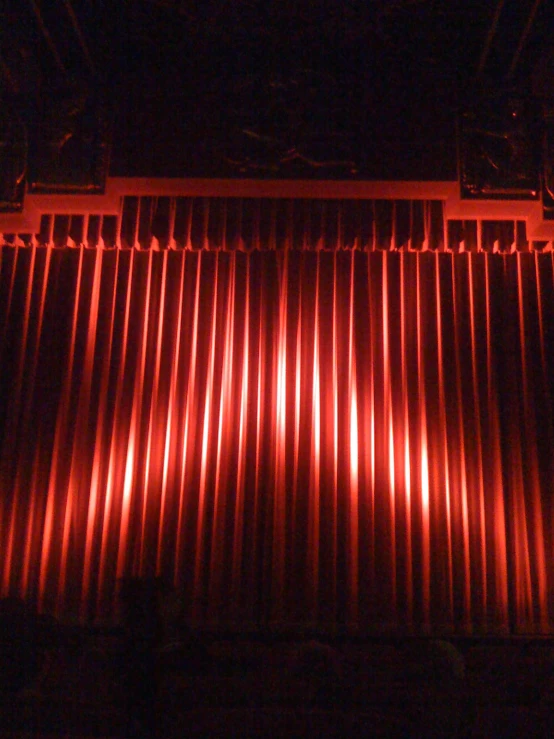 a theatre stage with red curtains and lights on it