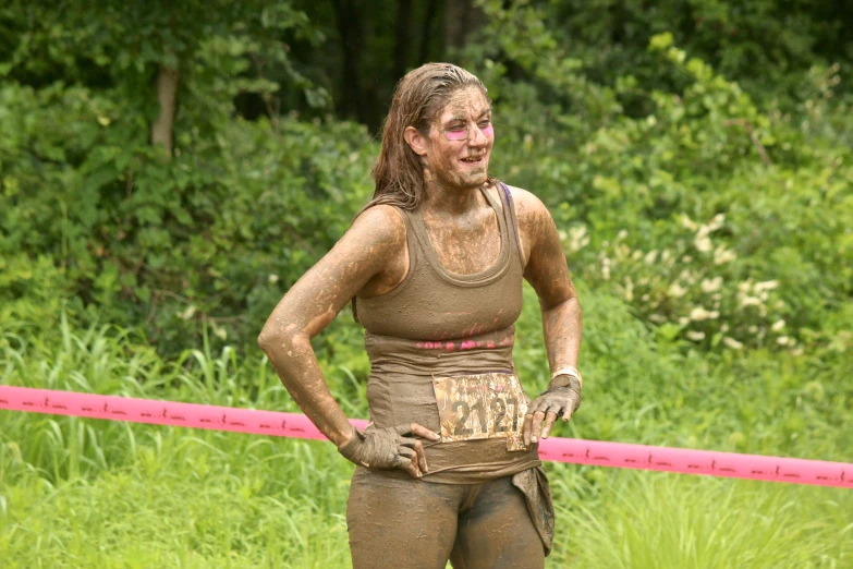 a young man in mud clothes during a race
