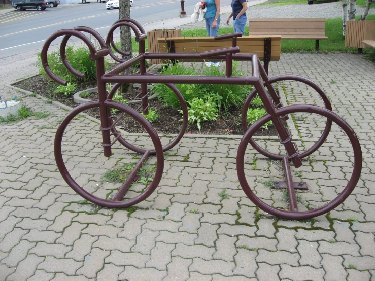 a bicycle bench on the side of a street