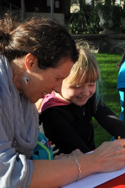 woman with small child doing art projects in a park