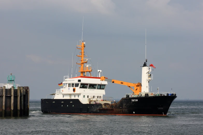 the large ship is in the water near the dock