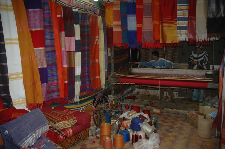 this is a bed room that has several different colored beds