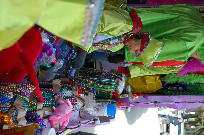 two people at a stand selling beads and accessories