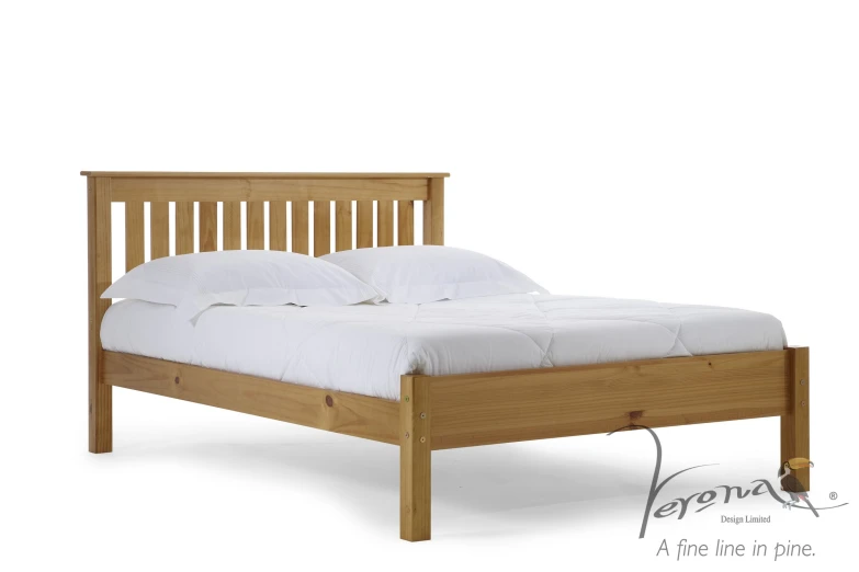 the bed has white sheets and wooden headboard