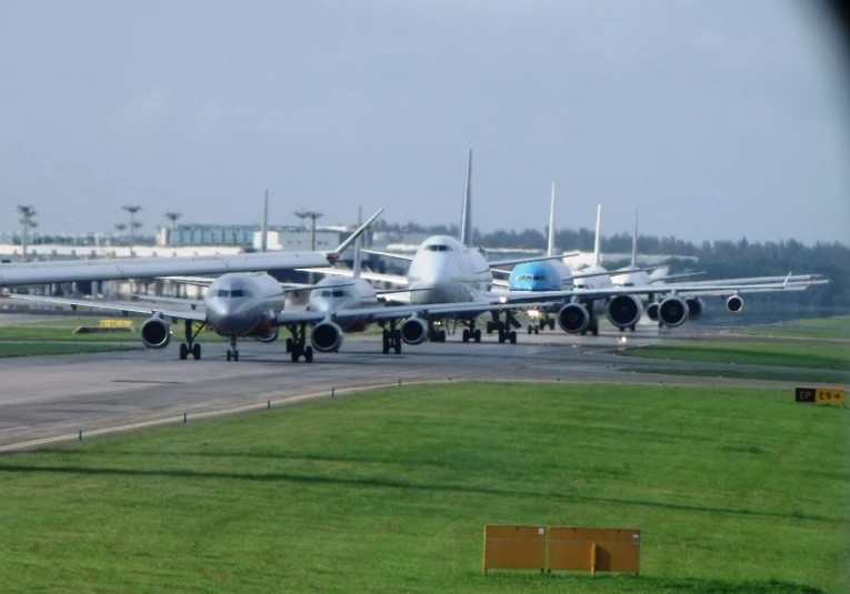 a row of airplanes parked at the airport