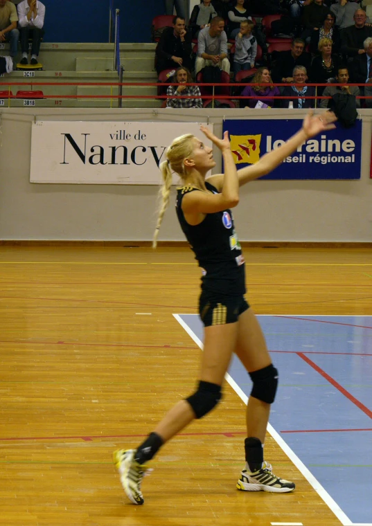 a lady gets ready to hit a volleyball