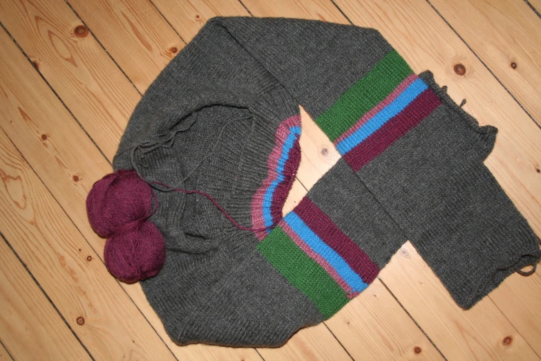 a knit hat and a pair of leggings laying on the floor