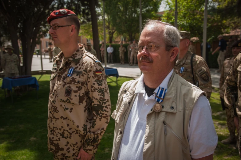 some men wearing military uniforms are outside