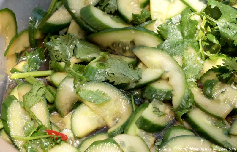 green vegetables are mixed with spices in the bowl