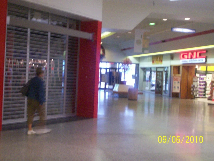 a woman is walking through an entrance way