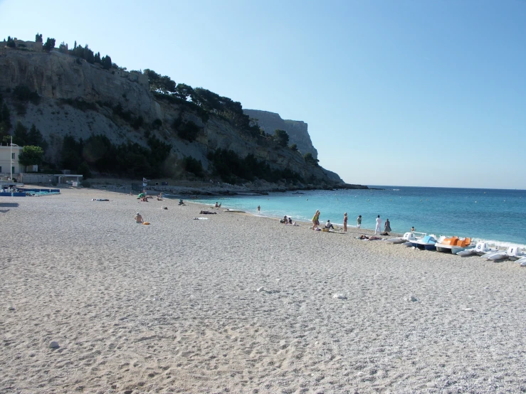 many people are on a beach by the ocean