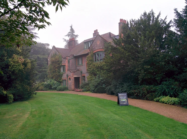 a very large pretty house in the middle of some grass