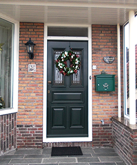 the front porch is adorned with flowers and a wreath