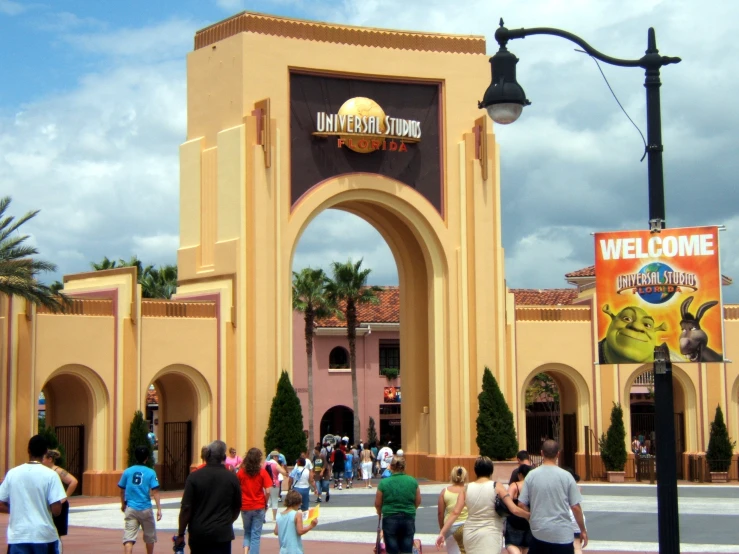 some people are walking around the entrance to a large building