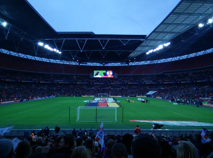 an empty stadium with lights on as it plays a soccer game