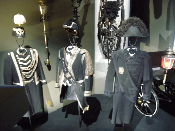 the costumed and worn outfits in this museum display