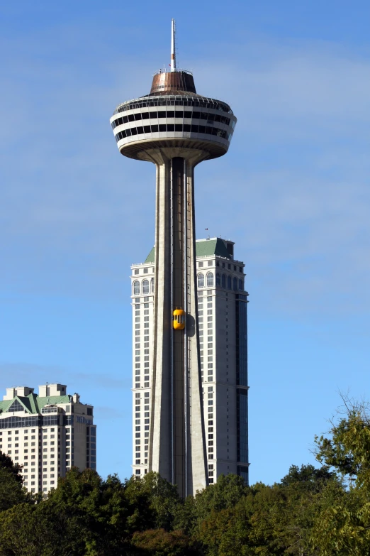 a very tall building with a big tower and a train passing by