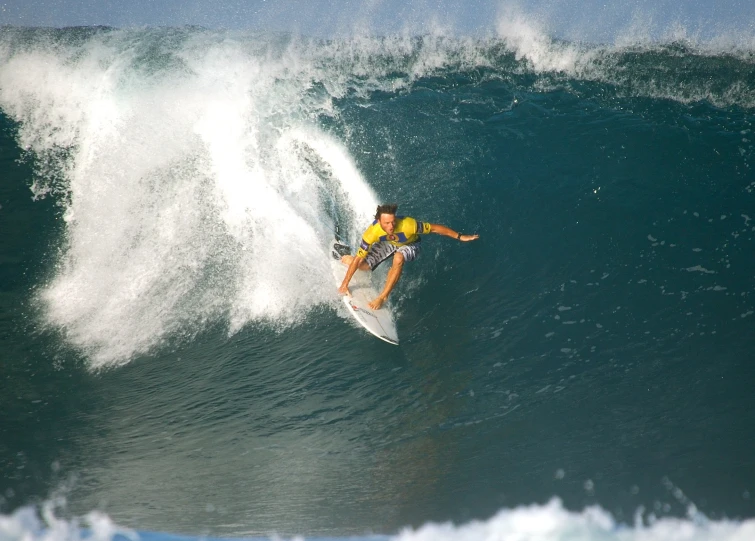 a man riding a wave on top of a surfboard